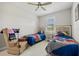 This bedroom features two twin beds with fun character bedding and a comfortable armchair at 111 Britt Rd, Rotonda West, FL 33947