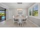 Dining area with pool views, featuring a modern light fixture and shuttered windows at 111 Britt Rd, Rotonda West, FL 33947
