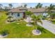 Beautiful home featuring a paved driveway, lush landscaping, and a two-car garage at 111 Britt Rd, Rotonda West, FL 33947