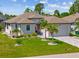 Charming single-story home with well-maintained landscaping, paver driveway, and welcoming curb appeal at 111 Britt Rd, Rotonda West, FL 33947