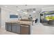 Open kitchen island with sink and dishwasher with view of the living room and lanai at 111 Britt Rd, Rotonda West, FL 33947