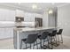 Bright kitchen features white cabinets, stainless appliances, stone counters and island with seating at 111 Britt Rd, Rotonda West, FL 33947