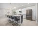 Modern kitchen featuring white cabinetry, stainless steel appliances, a large center island, and stylish pendant lighting at 111 Britt Rd, Rotonda West, FL 33947