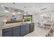 Open kitchen island with sink and dishwasher, flows into living and dining areas and overlooks pool at 111 Britt Rd, Rotonda West, FL 33947
