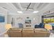 Bright living room with large sliding doors to outdoor living area, coffered ceiling, and comfortable furniture at 111 Britt Rd, Rotonda West, FL 33947