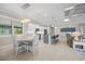 Open concept kitchen with island seating flows into the dining and living spaces at 111 Britt Rd, Rotonda West, FL 33947