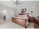 Spacious main bedroom featuring a ceiling fan, ensuite bathroom and natural light from the windows at 111 Britt Rd, Rotonda West, FL 33947