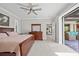 Spacious main bedroom with access to the outdoor patio, featuring a ceiling fan at 111 Britt Rd, Rotonda West, FL 33947