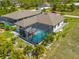 An aerial view of a screened in pool with patio furniture at 111 Britt Rd, Rotonda West, FL 33947