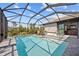 This screened-in pool area includes an inviting pool and outdoor seating for enjoying the sun at 111 Britt Rd, Rotonda West, FL 33947