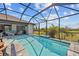 A screened-in pool area with a clear blue pool and plenty of space for lounging on the patio at 111 Britt Rd, Rotonda West, FL 33947
