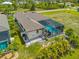 Aerial view of the home's screened pool, patio, and lush tropical landscaping at 111 Britt Rd, Rotonda West, FL 33947