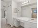 Bright bathroom featuring double vanity, neutral color palette, and a tiled shower area at 118 Naomi Pl, Rotonda West, FL 33947