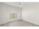 Bright bedroom with neutral walls, wide window, fan, and sleek gray flooring at 118 Naomi Pl, Rotonda West, FL 33947
