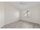 A bright and spacious bedroom with wood-look flooring and a ceiling fan at 118 Naomi Pl, Rotonda West, FL 33947