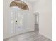 Elegant entryway featuring modern flooring, a decorative front door, and ample natural light at 118 Naomi Pl, Rotonda West, FL 33947