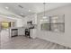 Bright kitchen with stainless steel appliances, white cabinets, breakfast bar, and backyard views at 118 Naomi Pl, Rotonda West, FL 33947