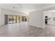 Open living area with access to lanai and outdoor pool, showcasing modern flooring and abundant light at 118 Naomi Pl, Rotonda West, FL 33947