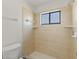 Shower featuring neutral tiling, built-in shelving, and a window at 118 Naomi Pl, Rotonda West, FL 33947