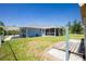 Spacious backyard featuring a screened-in porch and ample space for outdoor activities at 12185 Weimar Ave, Port Charlotte, FL 33981