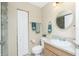 Well-lit bathroom featuring a vanity with a round mirror and a tiled shower at 12185 Weimar Ave, Port Charlotte, FL 33981
