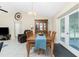 Inviting dining area with elegant wooden table, plenty of natural light, and a china cabinet at 12185 Weimar Ave, Port Charlotte, FL 33981