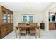 Bright dining area features a classic wooden table, chairs, and sliding glass doors to the patio at 12185 Weimar Ave, Port Charlotte, FL 33981