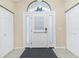 Bright foyer with tiled floor, decorative transom window, and convenient closet space at 12185 Weimar Ave, Port Charlotte, FL 33981