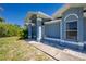 Charming exterior view of a single-Gathering home with a manicured lawn and carport at 12185 Weimar Ave, Port Charlotte, FL 33981