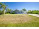 Charming single-story home featuring a well-manicured lawn and a carport at 12185 Weimar Ave, Port Charlotte, FL 33981