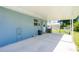 Exterior view showcasing a covered patio, adjacent to a well-kept yard, with a shed in the background at 12185 Weimar Ave, Port Charlotte, FL 33981
