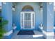 Inviting front entrance with decorative security door, side windows, and cute dog statues at 12185 Weimar Ave, Port Charlotte, FL 33981