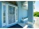 Home's inviting front entrance with security door and accent flower box at 12185 Weimar Ave, Port Charlotte, FL 33981