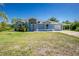Single-story home featuring a well-kept lawn, attached garage, and carport at 12185 Weimar Ave, Port Charlotte, FL 33981