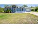 Charming single-story home with a well-manicured lawn and attached carport at 12185 Weimar Ave, Port Charlotte, FL 33981