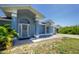 Charming single-story home with blue exterior, decorative front door, and well-maintained landscaping at 12185 Weimar Ave, Port Charlotte, FL 33981