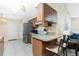 Kitchen featuring a breakfast bar, stainless steel refrigerator, and wood cabinetry at 12185 Weimar Ave, Port Charlotte, FL 33981