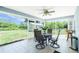 Screened-in lanai providing a relaxing outdoor space with a table set and backyard views at 12185 Weimar Ave, Port Charlotte, FL 33981