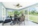 Enclosed lanai featuring a ceiling fan, tile flooring, and views of the outdoor space at 12185 Weimar Ave, Port Charlotte, FL 33981