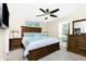 Relaxing main bedroom featuring a large bed, ceiling fan, and window seat with backyard view at 12185 Weimar Ave, Port Charlotte, FL 33981