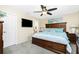 Tranquil main bedroom with wooden furniture, mounted TV and decorative coastal accents at 12185 Weimar Ave, Port Charlotte, FL 33981