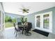 Covered patio with a dining set, ceiling fan, and tiled floor for outdoor enjoyment at 12185 Weimar Ave, Port Charlotte, FL 33981