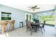 Covered patio with a dining set, and tiled floor for outdoor relaxation and entertainment at 12185 Weimar Ave, Port Charlotte, FL 33981