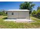 Exterior view of a well-maintained shed featuring a door, window, and clean surroundings at 12185 Weimar Ave, Port Charlotte, FL 33981