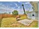 Spacious backyard featuring a patio, lush trees, and a privacy fence at 13495 Newport Ave, Port Charlotte, FL 33981