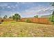 Spacious fenced backyard with a palm tree provides a private outdoor area for relaxing or entertaining at 13495 Newport Ave, Port Charlotte, FL 33981