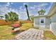 Backyard with a patio, barbecue, and palm tree creates an inviting outdoor space for gatherings at 13495 Newport Ave, Port Charlotte, FL 33981