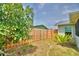 Cozy backyard with a wood fence and some foliage offering privacy and a relaxing outdoor space at 13495 Newport Ave, Port Charlotte, FL 33981