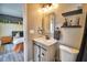 Stylish bathroom featuring modern light fixtures, a sink and mirror, and a decorative towel bar at 13495 Newport Ave, Port Charlotte, FL 33981