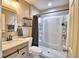 Tastefully updated bathroom featuring modern vanity, updated shower and flooring, and a linen closet at 13495 Newport Ave, Port Charlotte, FL 33981